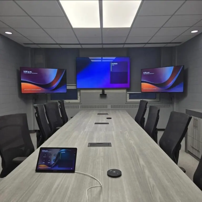 Three wall-mounted displays in a conference room installation